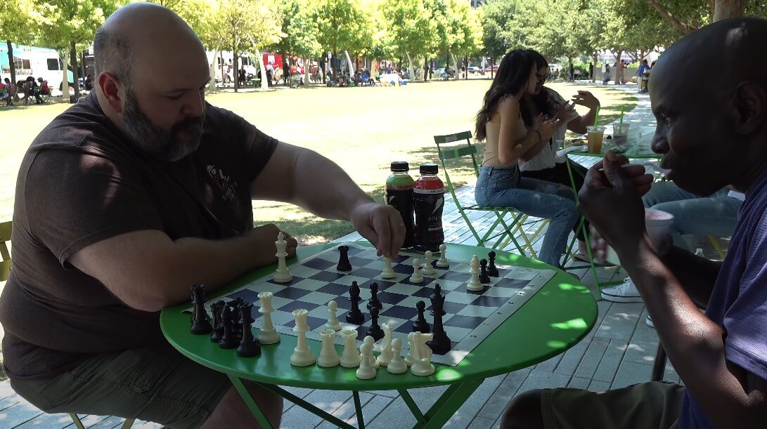 Two friends playing chess in the park