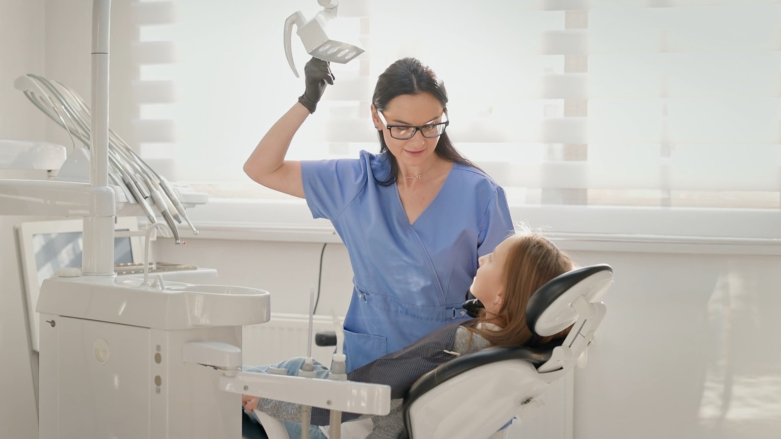 A woman dentist examining woman patient